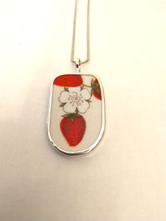 Broken China Jewelry, Pendant. Sterling Silver,  "STRAWBERRIES & FLOWER "   Every piece of  broken china is unique and carefully handcrafted .These Pendants  Have the artists name On Them and 925. All pieces are bezelled in fine silver back and Bail Are sterling Have a damaged heirloom plate ? Why not send it to us-we can make you and other family members one of a kind pendants and rings from your cherished plate. Silver Strawberries, Rabbit Ring, Strawberry Flower, Artisan Jewelry Necklaces, Broken China Jewelry, China Jewelry, Broken China, Jewelry Pendants, Handcrafted Artisan Jewelry