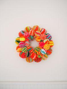 a multicolored wreath hanging on the wall