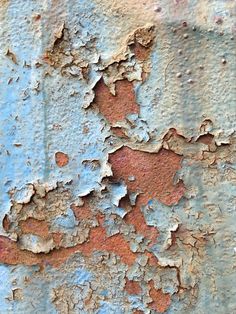 an old rusted metal surface with peeling paint