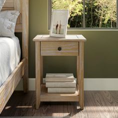 a bed room with a neatly made bed and a small wooden table next to it