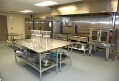 an industrial kitchen with stainless steel appliances and counters