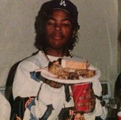 a man holding a plate with food on it