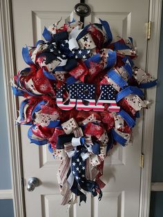 a patriotic wreath hanging on the front door