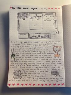 an open notebook with doodles and drawings on the pages, including a drawing of a kitchen