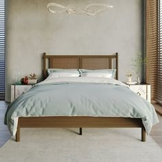 a bedroom with a bed, nightstands and windows