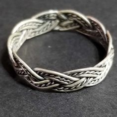 Vintage sterling silver light weight braided wire band ring with antiqued and tarnished finish. Wonderful craftsmanship. The back of the ring is the braid soldered together. Our family acquired this ring around 1996, as part of a large jewelry collection. It's in great condition, unworn, antiqued and tarnished. It's been in storage all of these years. ► SHIPPING INFO Shipped from California via USPS All vintage sterling silver jewelry may have antiquing or tarnish. If you like Celtic and similar Vintage Sterling Silver Jewelry, Celtic Ring, Braid Jewelry, Silver Gift Wrap, Vintage Silver Rings, Womens Ring, Braided Ring, Ring Mens, Small Jewelry Box