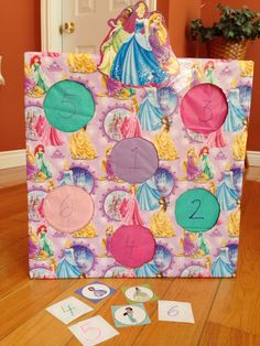 a bag with numbers and princesses on it sitting on top of a wooden floor