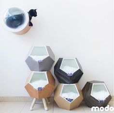 four cement hexagonal tables sitting on top of a tile floor next to a white wall