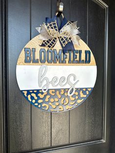 a door hanger that says, bloomted bees with leopard print and bows on it