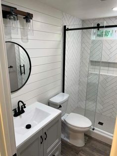 a white toilet sitting next to a walk in shower