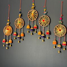 several colorful ornaments hanging on a gray wall