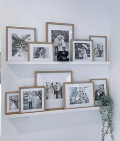 a wall with pictures and frames on it