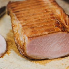 a piece of meat sitting on top of a wooden cutting board