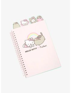 a pink notebook with hello kitty characters on it