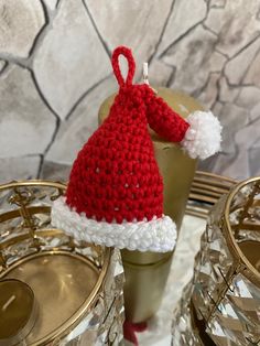 a crocheted santa hat sitting on top of a table