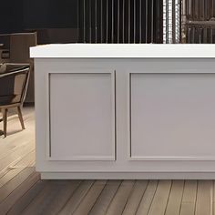 a white counter sitting on top of a wooden floor