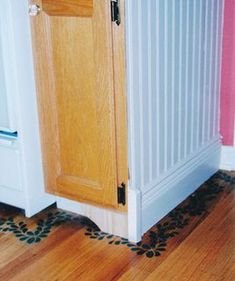 a wooden cabinet sitting on top of a hard wood floor next to a radiator