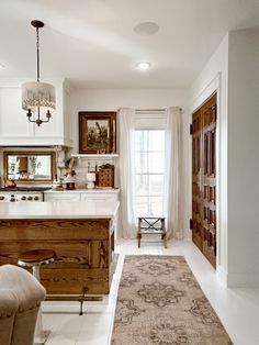 a kitchen with an area rug on the floor