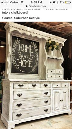 an old white dresser with chalkboard on top and flowers in the bottom drawer, next to it is a chalk board that says home sweet home