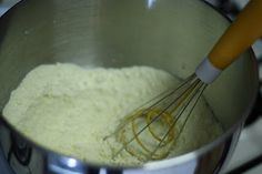 a mixing bowl filled with batter and whisk