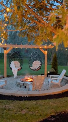 a fire pit surrounded by chairs and lights