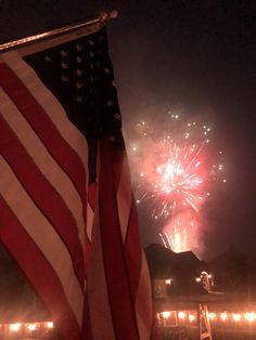 an american flag and fireworks in the sky