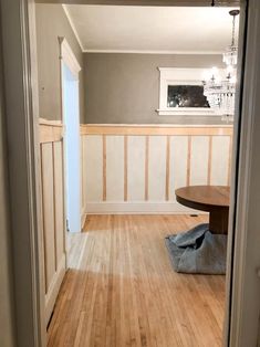 an empty room with wood flooring and white trim on the walls is seen in this image