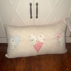 a pillow with hearts hanging from it on the floor