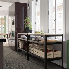 a kitchen with lots of boxes on the counter next to a potted plant and window