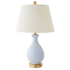 a blue lamp with a white shade on the base and a gold - plated base