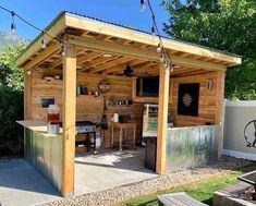 an outdoor kitchen is built into the side of a shed