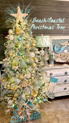 a white christmas tree with blue and gold ornaments