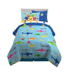 a child's bed with blue sheets and colorful animals on it