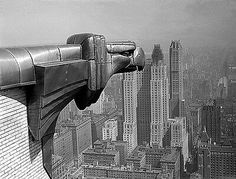 a black and white photo of the top of a building in new york city, ny