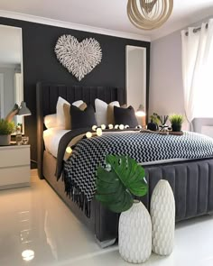 a bedroom with black and white decor on the walls