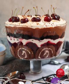 a trifle with cherries and whipped cream on top