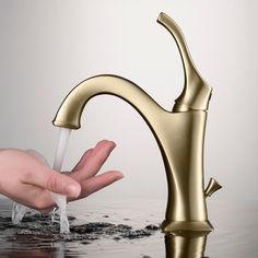 a person is washing their hands under a faucet