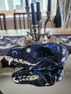 a close up of a plate on a table with a blue and white animal head