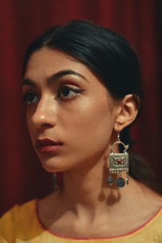 a close up of a person wearing earrings