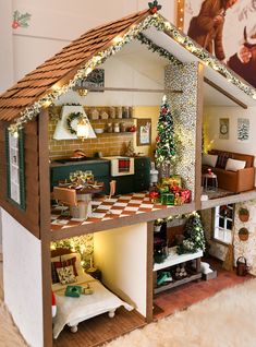 a doll house is decorated with christmas lights