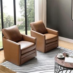 two brown leather chairs sitting on top of a black and white striped rug in front of a window