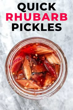 a jar filled with pickles sitting on top of a table