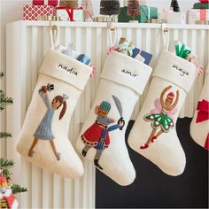 three christmas stockings hanging from the wall