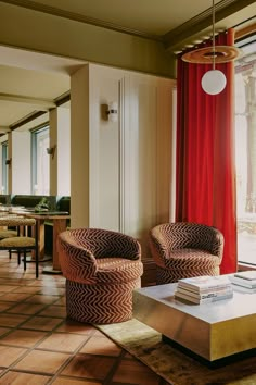 a living room with two chairs and a coffee table in front of a large window