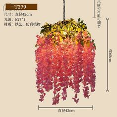 the hanging lamp is decorated with pink flowers and green leaves, it has a brown base