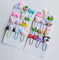 there are many small animal clips on the clothes pegs that have hair clips attached to them