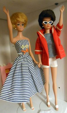 two barbie dolls dressed in clothes and sunglasses