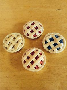 three small pies sitting on top of a wooden table