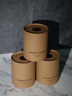 three rolls of brown paper sitting on top of a marble counter next to each other