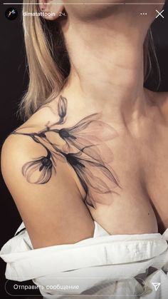 a woman's chest with a flower tattoo on her left shoulder and right breast